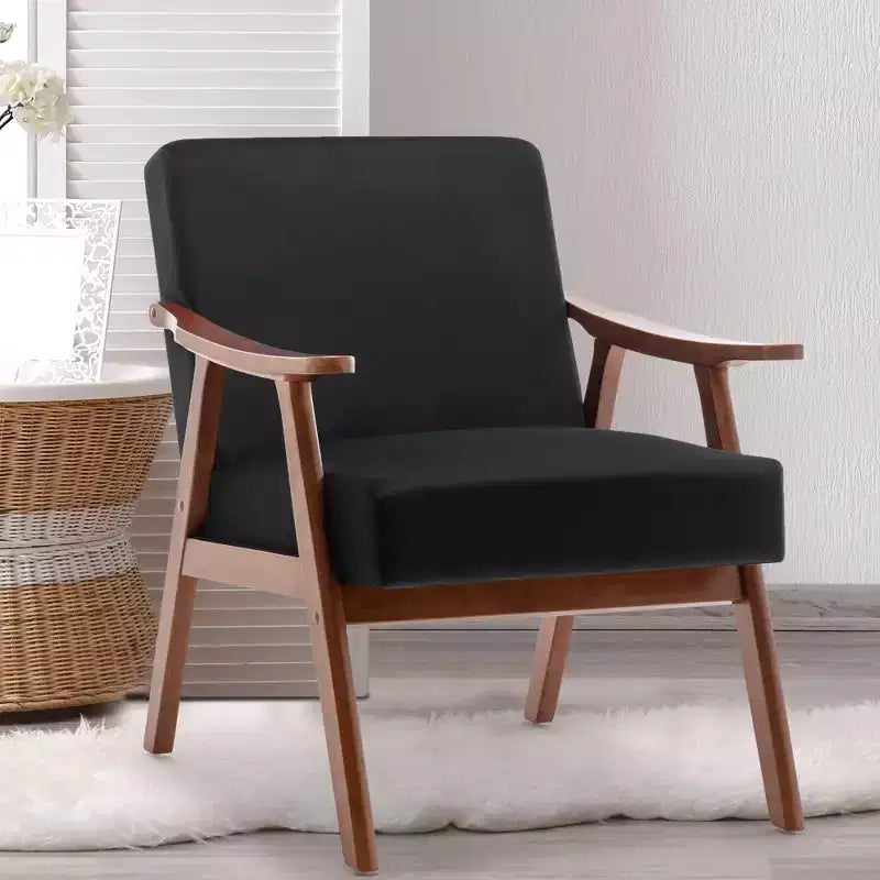 Poltroncina con schienale a orecchioni e gambe in legno massello