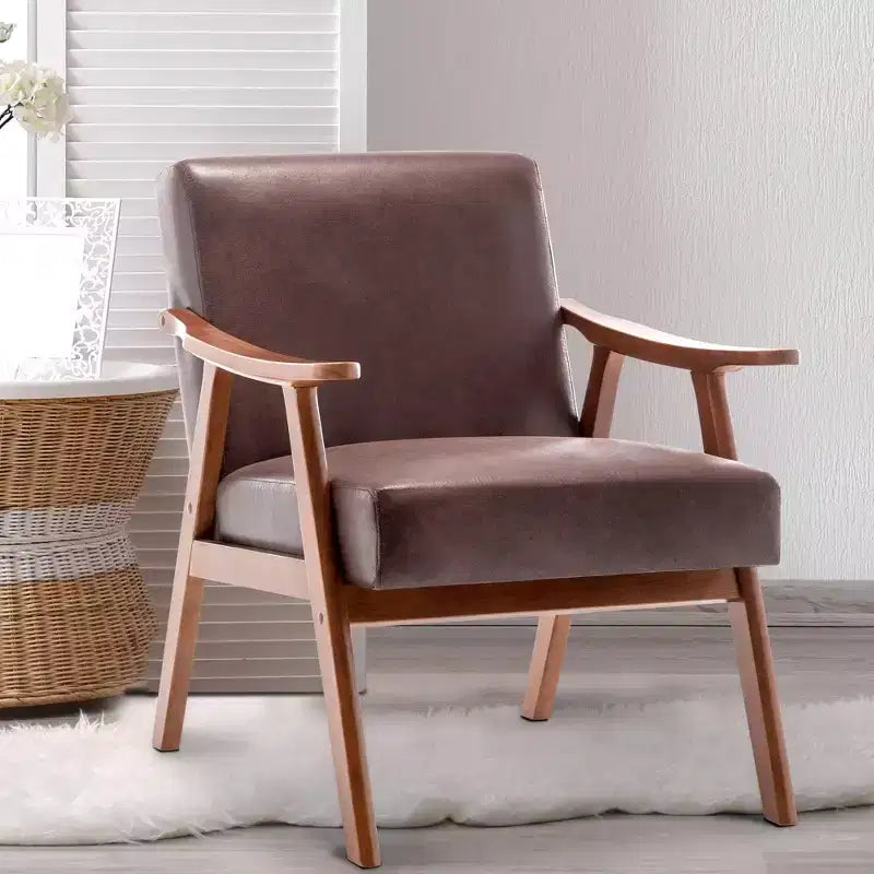Poltroncina con schienale a orecchioni e gambe in legno massello